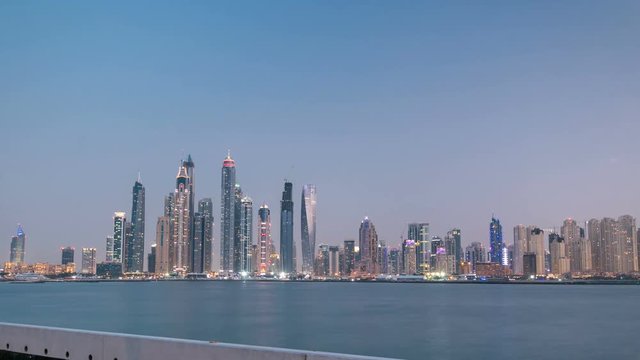 Dubai Marina skyline day to night timelapse as seen from Palm Jumeirah in Dubai, UAE. 