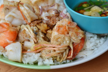 fried shrimp and squid with garlic on rice