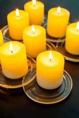 closeup to burning candles in darkness