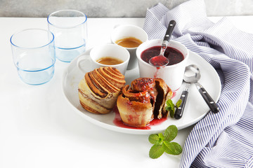 breakfast table with sweet rolls and raspberry jam