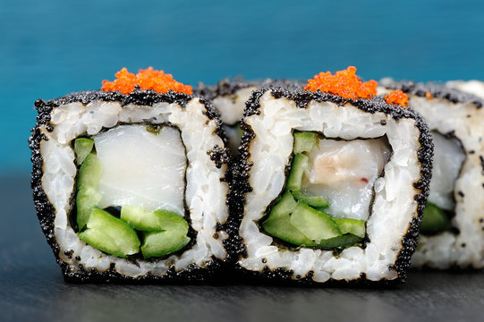 Set of delicious sushi rolls with white fish and cucumber