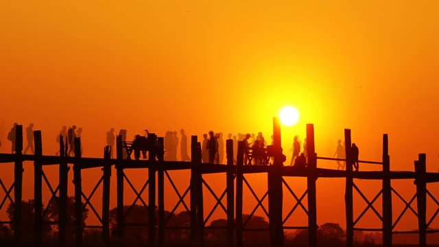 Famous U-Bein teak bridge at sunset on Taungthaman lake, Mandalay, Myanmar, zoom timelapse
