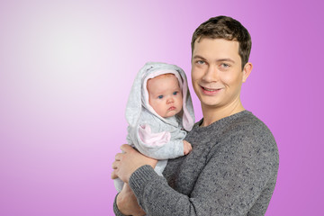 Happy young man holding a  baby