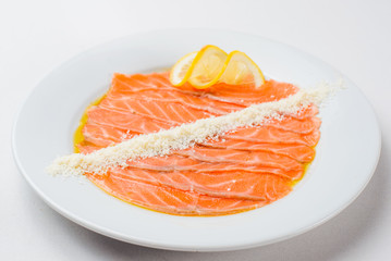 carpaccio of salmon in a white plate on a white background