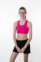 Fototapeta na wymiar young woman in pink sports wear isolated on white background