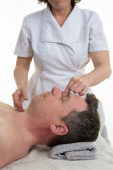 Obraz na płótnie Canvas Facial and cranial osteopathy therapy given by a female