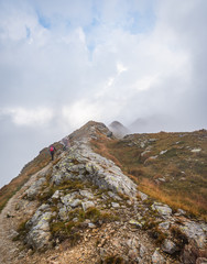 Hiking Trail with Tourists on the Hill in the Mountains in the Mist