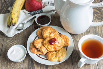 Banana cheese scones for Breakfast with jam,sour cream.Tea, fruit.