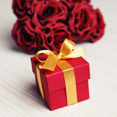 red flowers and gift box with yellow ribbon 