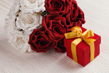 red flowers and gift box with yellow ribbon 