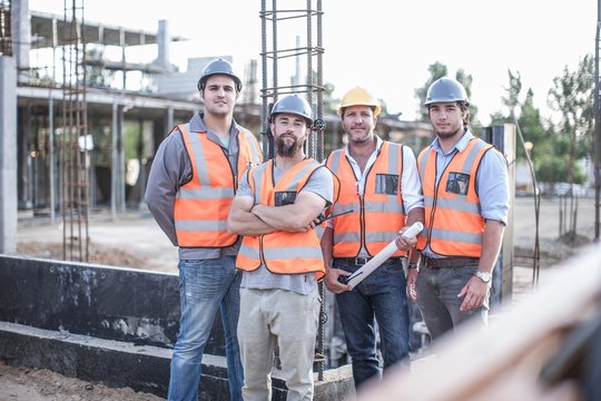 Portrait of site manager and building team on construction site