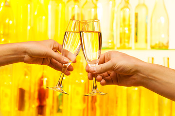 Man and woman hands holding champagne glasses