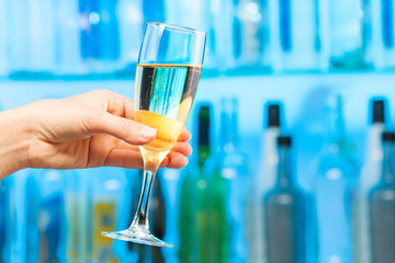 Woman hand toasting champagne in crystal glass