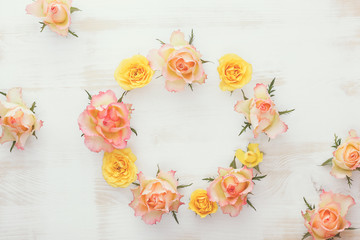 Wreath with fresh roses. Rose wreath in pastel color, rustic background