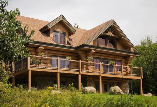Rear of Scandinavian cottage style log home and garden