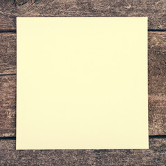 wooden background with blank paper