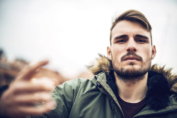 Handsome caucasian young man in casual clothes in urban environm