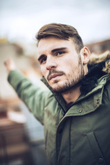 Handsome caucasian young man in casual clothes in urban environm