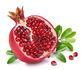 Pomegranate fruit with green leaves.