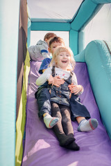 Children going down inflatable bouncy slide