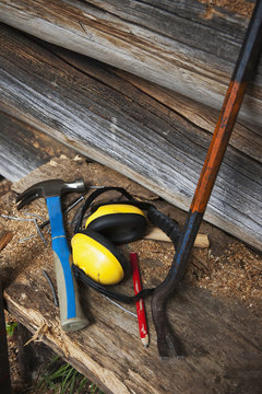Crowbar, hammer and ear defenders, high angle view