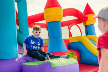 Two boys playing on inflatable castle