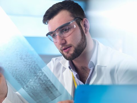 Scientist examining DNA code in laboratory