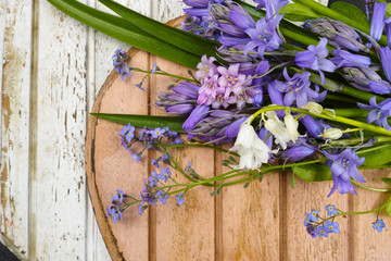 Bouquet with colorful wild hyacinths on wooden heart