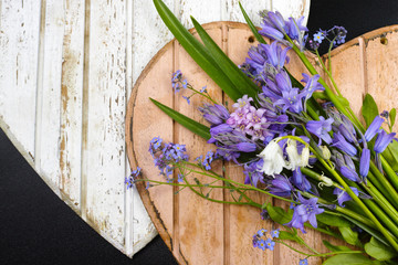 Bouquet with colorful wild hyacinths on wooden hearts
