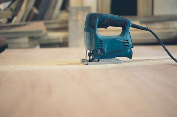 A jigsaw on a sheet of plywood