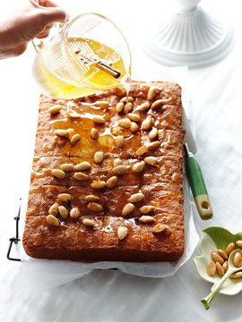 Pouring syrup on almond semolina cake