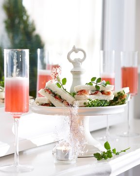 Champagne Flutes Of Pink Champagne And Crayfish Sandwiches On Cake Stand