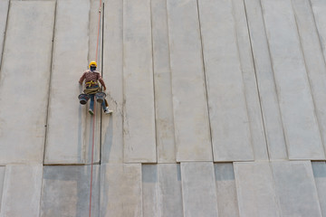 Construction worker and grey cement wall