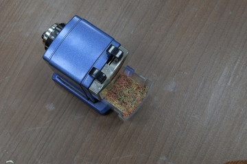 pencil sharpener with shavings on the wood
