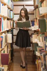 Girl reading book in library