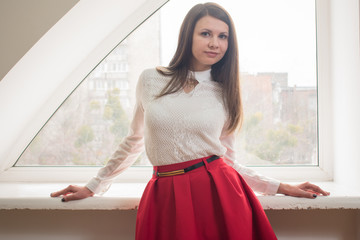 Beautiful girl in the office near the window
