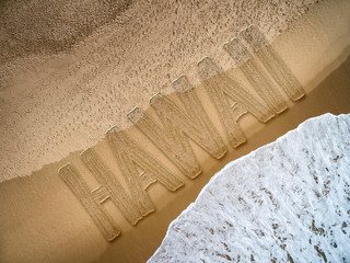 Hawaii written on the beach