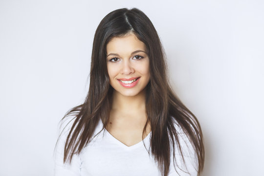 Beautiful woman smiling. Young Female touching Her Skin. Portrait on White Background. Perfect Skin. Beauty Face.