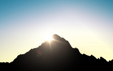 silhouette of mountain top over sky and sun light