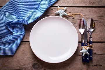 Marine table setting on aged wooden background.