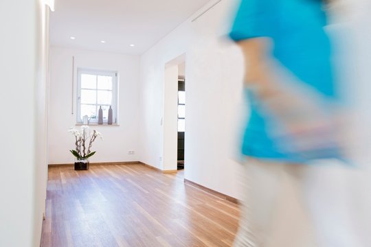 Blurred motion cropped view of nurse walking in clinic corridor