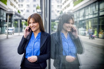 Smiling business woman in the street.