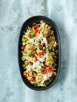 Persian lamb chicken kaftan, red peppers, pomegranate, rice, coriander, raisins