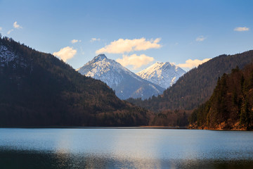 Fototapeta na wymiar Alpsee lake landscape with Alps mountains near Munich in Bavaria, Germany