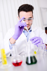 handsome young chemical biologist working in a laboratory