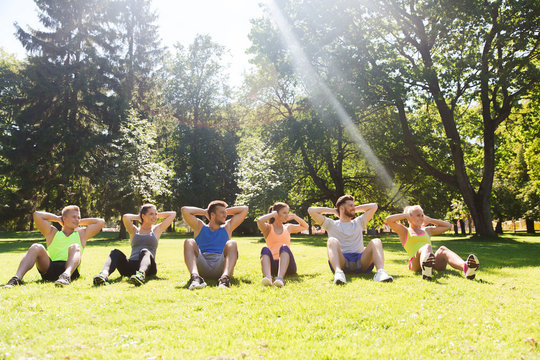 group of friends or sportsmen exercising outdoors