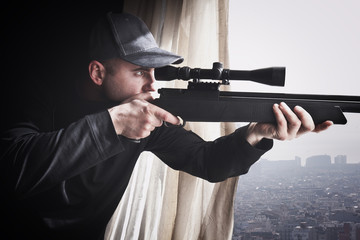 sniper man rifle caucasian window. concept security,danger,weapons,control