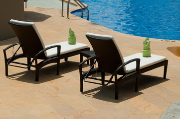Lounge Chairs By The Swimming Pool.