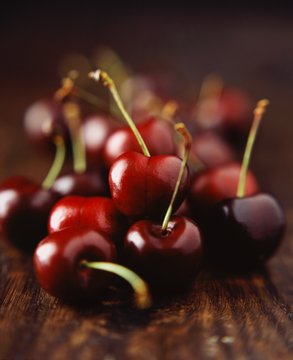 Fresh black cherries on wooden table, close-up
