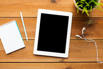 close up of tablet pc computer on wooden table